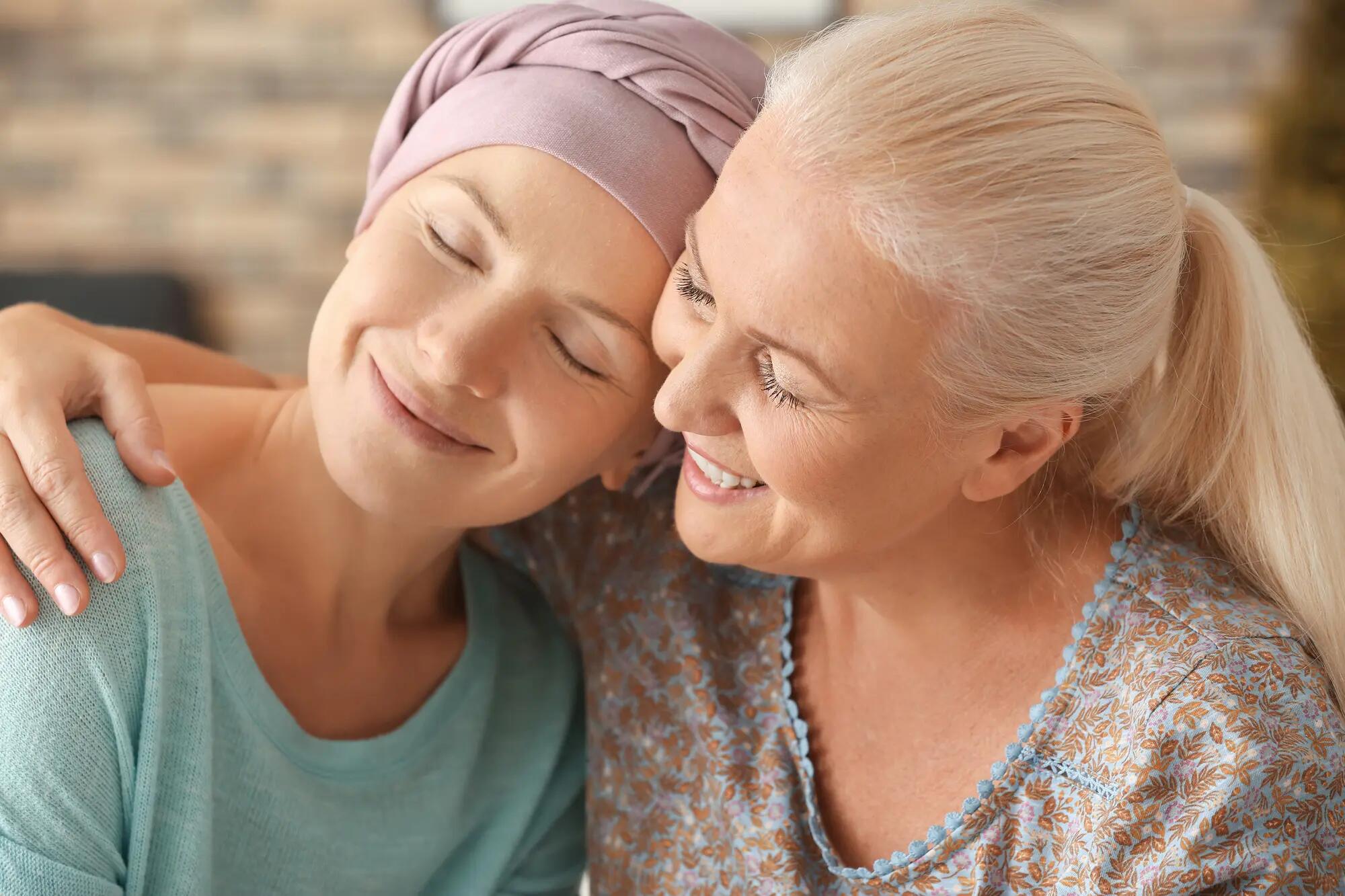 Woman embracing cancer patient