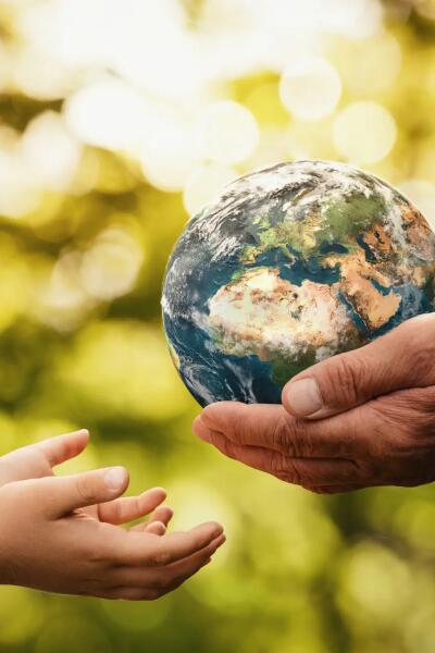 Senior hands giving earth to a child