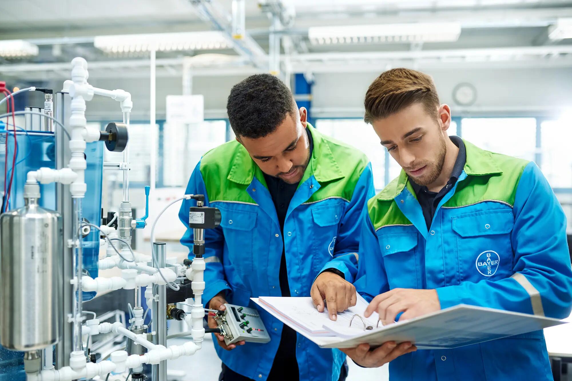 Trainees look in a manual
